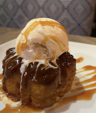 Warm cake dessert with vanilla ice cream and caramel sauce