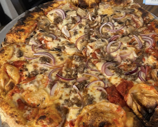 Meat lovers brick oven pizza with sausage and red onion