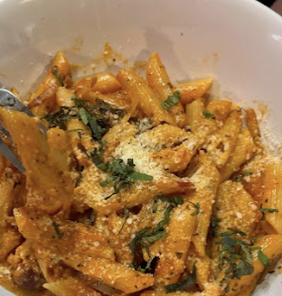 Penne pasta in a creamy tomato sauce with parmesan and basil